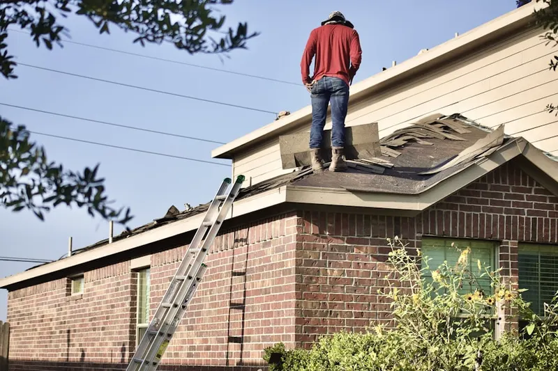 Professional roofer working on a residential roof in Ramblewood